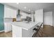Bright, airy kitchen featuring a large island, stainless appliances, and stylish bar stools at 650 Bishop Pine Way, Castle Rock, CO 80104