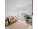Bright living room features modern decor, stylish lighting, and a large window with neighborhood view at 650 Bishop Pine Way, Castle Rock, CO 80104
