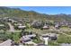 An aerial view of the property with mountain views showing landscaping and multi-car garage at 10950 Elk Horn Run, Littleton, CO 80125