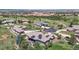 Stunning aerial view of a luxury home with solar panels overlooking a golf course and scenic landscape at 10950 Elk Horn Run, Littleton, CO 80125