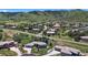 An aerial view of the property with mountain views showing landscaping and multi-car garage at 10950 Elk Horn Run, Littleton, CO 80125