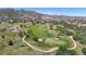 Breathtaking aerial view of golf course, mountains, and picturesque community at 10950 Elk Horn Run, Littleton, CO 80125