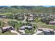 An aerial view of the property with mountain views showing landscaping and multi-car garage at 10950 Elk Horn Run, Littleton, CO 80125