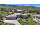 Overhead view of a single-story home, featuring a three-car garage, verdant yard, and beautiful mountain views at 10950 Elk Horn Run, Littleton, CO 80125