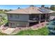 Back exterior view of a home featuring a balcony, solar panels, and landscaped backyard at 10950 Elk Horn Run, Littleton, CO 80125