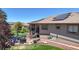 Backyard patio area featuring a grill, dining table, and solar panels at 10950 Elk Horn Run, Littleton, CO 80125