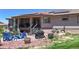 Outdoor patio features furniture, a grill, and landscaping with red rocks in this gray home's backyard at 10950 Elk Horn Run, Littleton, CO 80125