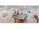 Finished basement with beautiful wood flooring and a pool table for entertaining guests at 10950 Elk Horn Run, Littleton, CO 80125
