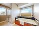 Bright bathroom featuring a tub, shower, and window overlooking scenic views at 10950 Elk Horn Run, Littleton, CO 80125