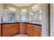 Bathroom with spacious vanity with black countertop and ample lighting at 10950 Elk Horn Run, Littleton, CO 80125