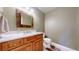 Cozy bathroom with wood vanity, attractive mirror, and neutral tones at 10950 Elk Horn Run, Littleton, CO 80125