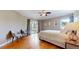 Bedroom featuring hardwood floors, balcony access, and plenty of sunlight at 10950 Elk Horn Run, Littleton, CO 80125