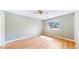 Light-filled bedroom with hardwood floors, ceiling fan, and large window at 10950 Elk Horn Run, Littleton, CO 80125