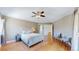 Bright bedroom with hardwood floors, fan, and neutral decor at 10950 Elk Horn Run, Littleton, CO 80125