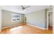 Light filled bedroom featuring a large window and hardwood floors at 10950 Elk Horn Run, Littleton, CO 80125