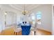 Elegant dining room with natural light, stylish chandelier, and designer furnishings at 10950 Elk Horn Run, Littleton, CO 80125