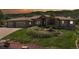 Beautifully landscaped home exterior featuring a three-car garage and lush front yard with an eye-catching ornamental garden at 10950 Elk Horn Run, Littleton, CO 80125