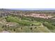 Aerial of the golf course and greenery with rocks and lakes in background at 10950 Elk Horn Run, Littleton, CO 80125