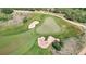 A clear shot of a golf course from above, featuring a well-maintained green and surrounding sand traps at 10950 Elk Horn Run, Littleton, CO 80125