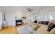 Bright living room featuring a fireplace, hardwood floors, and modern decor at 10950 Elk Horn Run, Littleton, CO 80125