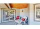 Cozy porch with white wicker furniture and a tongue and groove ceiling, perfect for relaxing and enjoying the outdoors at 10950 Elk Horn Run, Littleton, CO 80125