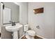 Contemporary half bathroom featuring a pedestal sink and modern fixtures at 6105 N Hanover St, Denver, CO 80238