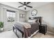 Carpeted bedroom with a large window, ceiling fan, queen bed and side table at 6105 N Hanover St, Denver, CO 80238