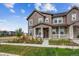 Charming two-story home with a covered front porch, manicured lawn, and beautiful landscaping at 6105 N Hanover St, Denver, CO 80238