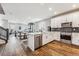 Open-concept kitchen with stainless steel appliances and adjacent dining and living areas at 6105 N Hanover St, Denver, CO 80238