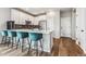 Modern kitchen with white cabinets, stainless steel appliances, and a breakfast bar at 6105 N Hanover St, Denver, CO 80238