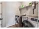 Laundry area with front loading washer and dryer, as well as storage shelving at 6105 N Hanover St, Denver, CO 80238