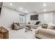 A cozy, carpeted living room features three couches, a glass table, and a window at 6105 N Hanover St, Denver, CO 80238