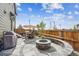 Backyard patio with a built-in fire pit, dining set, grill, and custom seating area at 6105 N Hanover St, Denver, CO 80238