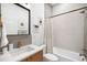 Full bathroom featuring tiled walls, sleek fixtures, and a shower/tub combination at 553 Monroe St, Denver, CO 80206