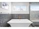 Stylish bathroom featuring a modern soaking tub and window with natural light at 553 Monroe St, Denver, CO 80206