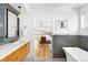 Bathroom features a vanity with double sinks, a bathtub, and a peek into the primary bedroom at 553 Monroe St, Denver, CO 80206