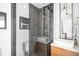 Modern bathroom with glass shower, stylish herringbone tile, and floating vanity at 553 Monroe St, Denver, CO 80206