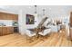 Open concept dining room with modern lighting fixtures, a wood table, and white chairs at 553 Monroe St, Denver, CO 80206