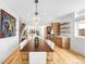 Dining room featuring modern light fixtures and an open floor plan leading to the living area at 553 Monroe St, Denver, CO 80206