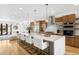 Bright kitchen features a large island with seating, modern appliances, and wood cabinetry at 553 Monroe St, Denver, CO 80206