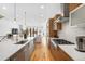 Modern kitchen with a large island, stainless steel appliances, and hardwood floors at 553 Monroe St, Denver, CO 80206