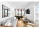 Living room features bright interior with a large window, cozy seating, and hardwood floors at 553 Monroe St, Denver, CO 80206