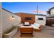 Cozy backyard patio with modern seating, a stylish privacy wall, and drought-tolerant gravel landscaping at 553 Monroe St, Denver, CO 80206