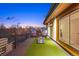 Spacious rooftop deck with artificial grass, comfortable seating, and panoramic neighborhood views for outdoor enjoyment at 553 Monroe St, Denver, CO 80206