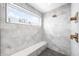 Tiled shower with a built-in bench and window overlooking the snowy outdoors at 553 Monroe St, Denver, CO 80206