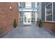 Modern building entrance with brick facade and landscaping at 1488 Madison St # 505, Denver, CO 80206