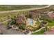 Stunning aerial view showcasing the community's pool, clubhouse, ample parking, and lush landscaping at 4474 Copeland Cir # 102, Highlands Ranch, CO 80126
