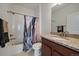 Bright bathroom featuring vanity with granite countertop and tub and shower combo with neutral ceramic tile at 4474 Copeland Cir # 102, Highlands Ranch, CO 80126