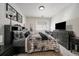 Well-lit bedroom featuring a cozy bed with plush bedding, desk, dresser, and neutral color palette at 4474 Copeland Cir # 102, Highlands Ranch, CO 80126