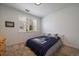 Bright bedroom featuring a Yankees themed bed, neutral carpeting, and lots of natural light at 4474 Copeland Cir # 102, Highlands Ranch, CO 80126